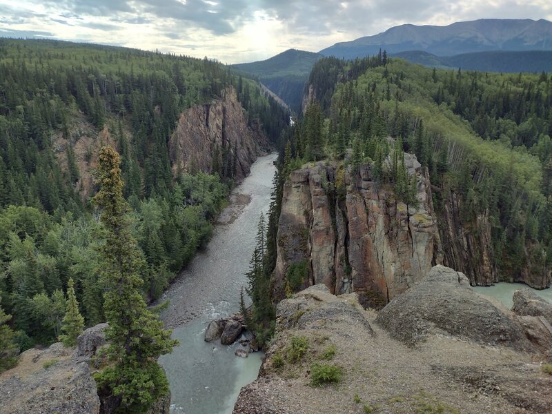 The Sulphur River flowing (upper center to lower center) through the Sulphur Gates (cliffs) to empty into the Smoky River approaching from the far right.