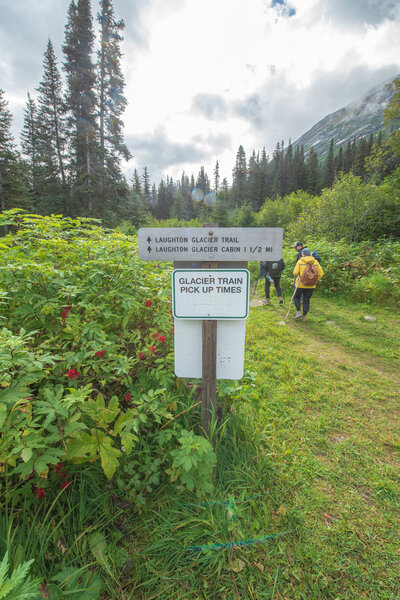 Trailhead sign and train times on the reverse side of the sign.