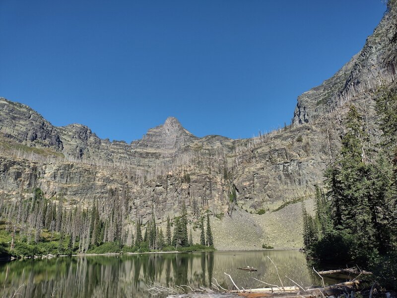Snyder Lake surrounded by impressive cliffs.  Little Matterhorn, 7,886 ft., (center) rises from the cliffs.