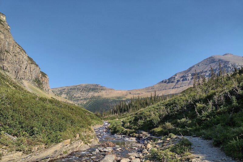 Siyeh Creek.  Mt. Siyeh, 10,014 ft., (right) is nearby to the north-northeast. Cliffs on the left are part of Piegan Mountain, 9,219 ft.