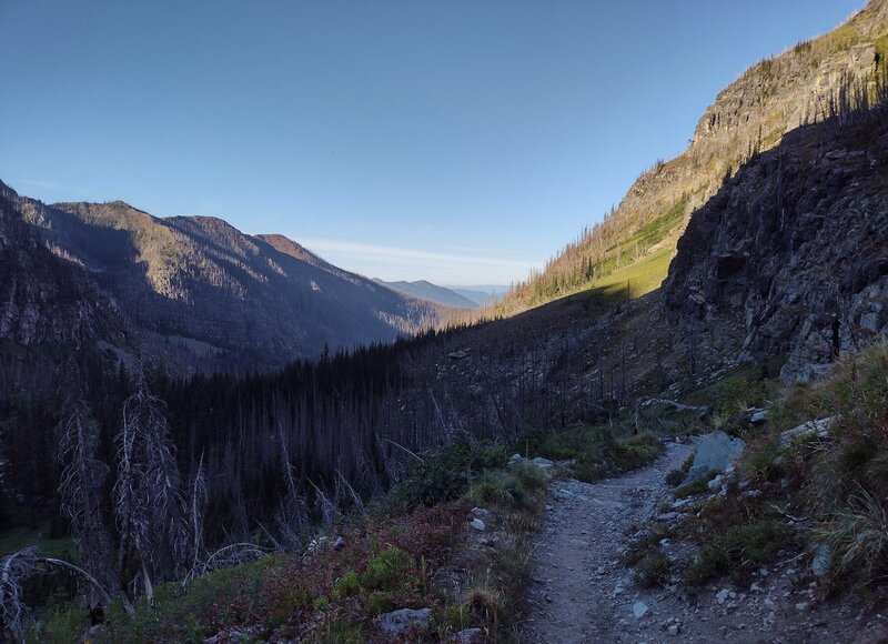 The view west-southwest down the Sprague Creek valley towards McDonald Lake in the early morning, from Gunsight Trail.