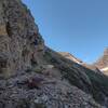 Daddy goat with mom and kid ahead on the trail to Gunsight Pass (right of center). Gunsight Mountain soars above the pass, on the right.