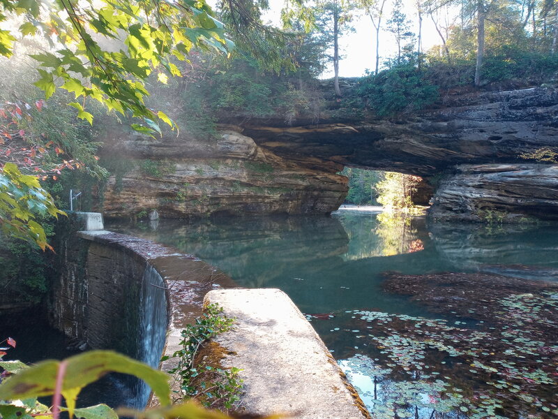 View across the top of the dam towards a natural bridge connection to the island.