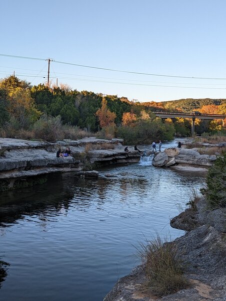 Waterfall with a bridge of Loop 360 in the background.