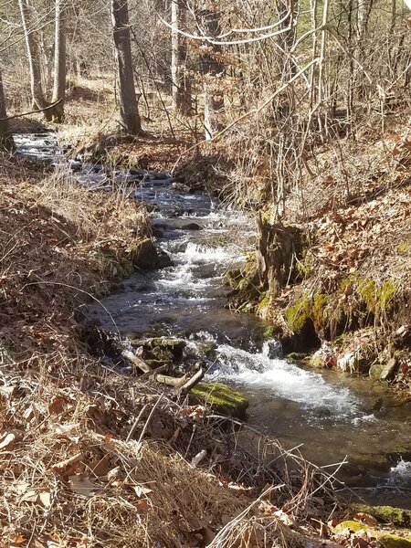 Beautiful water way that runs under a bridge leading to the PA DCNR park office with restaurants and maps.