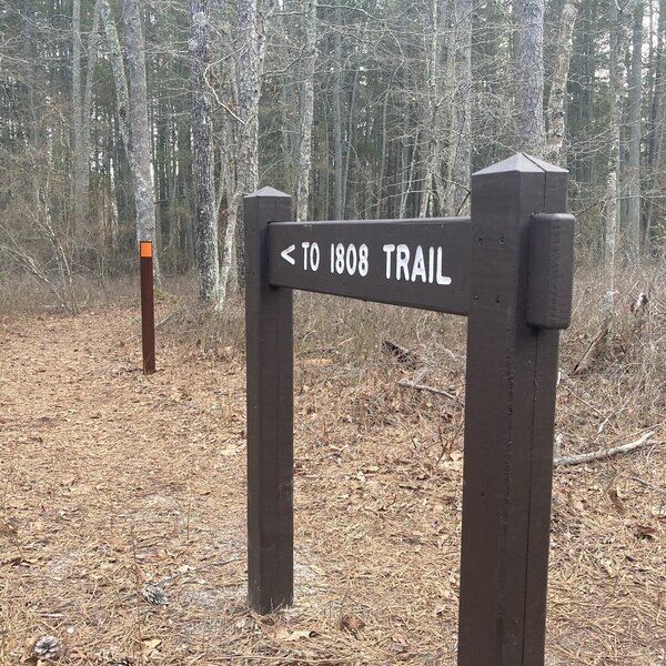 1808 Trail wood direction sign at the BATONA Trail