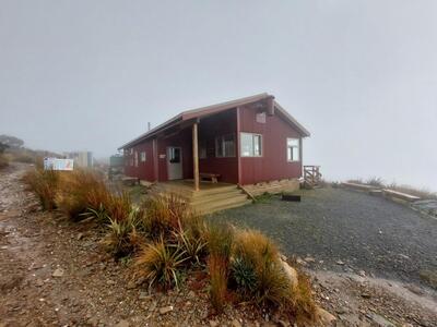 Moonlight Tops Hut sitting in the fog.