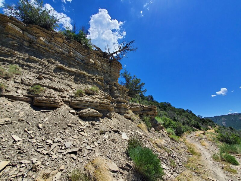 Crumbling cliffside with old wooden plaque