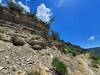 Crumbling cliffside with old wooden plaque