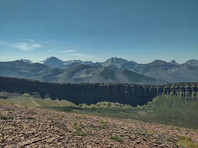 Looking down from high up on Lineham Ridge, the massive walls of the Great Divide are dwarfed by distance. Beyond the Great Divide, high mountains in British Columbia stretch on forever.