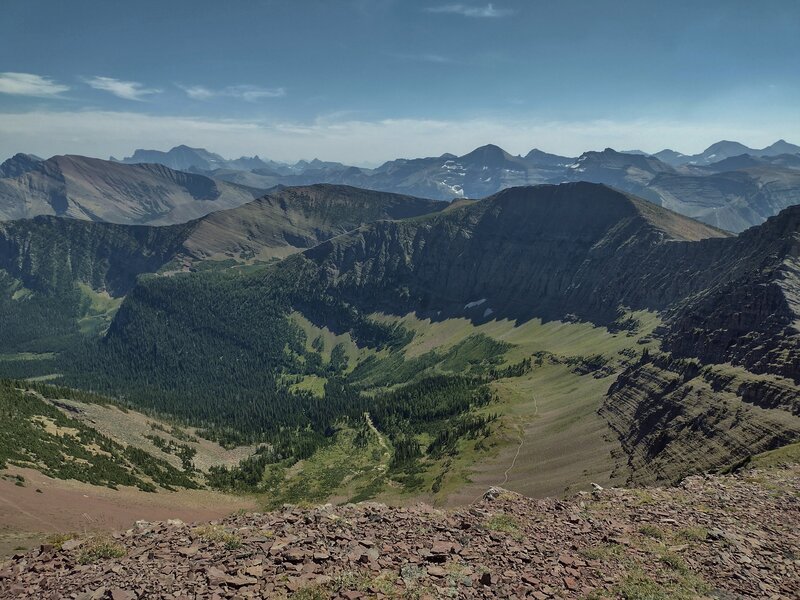 From Lineham Ridge, the trail on the south side of the ridge is etched in the shale at the foot of the Great Divide's rock wall, and at the edge of the green sub-alpine meadows below.