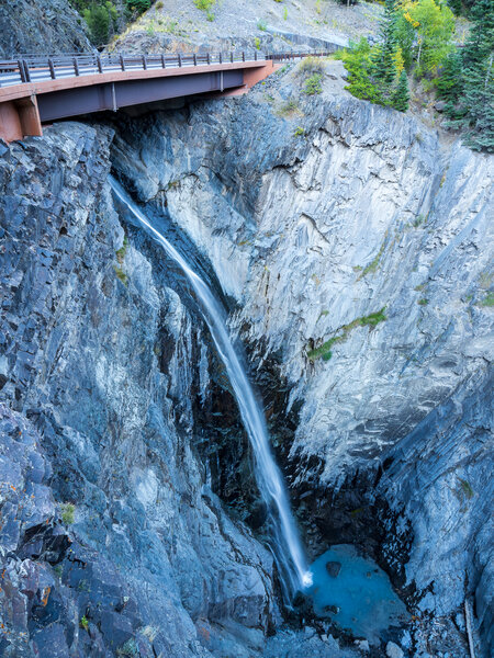 Bear Creek Falls flow directly underneath Highway 550.