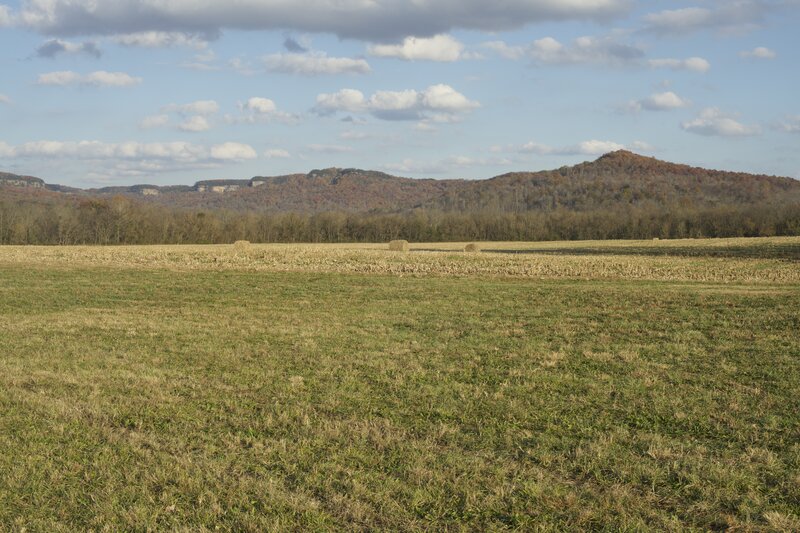 The trail passes through farmland in the valley with the Cumberland Mountains in the background.