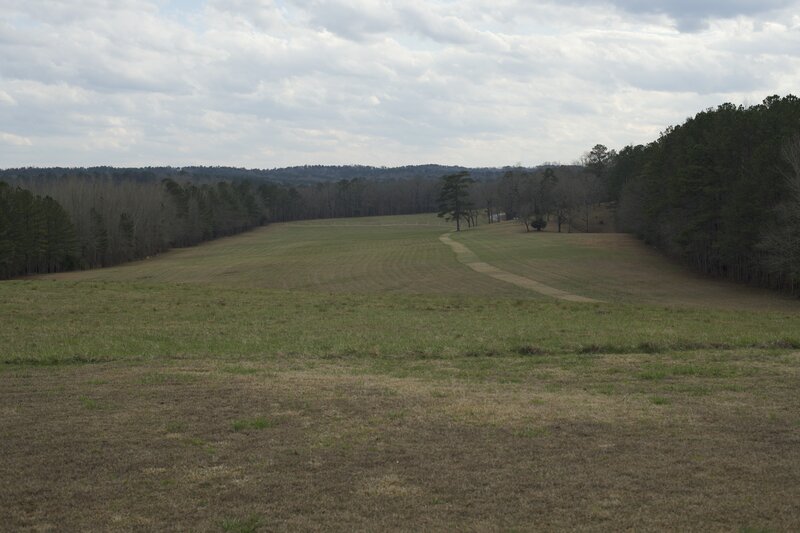 From the overlook, there is a nice view of the battlefield. You can see where the Red Stick Creek Indians built their log barricade to protect the peninsula, marked by the white posts in the distance.