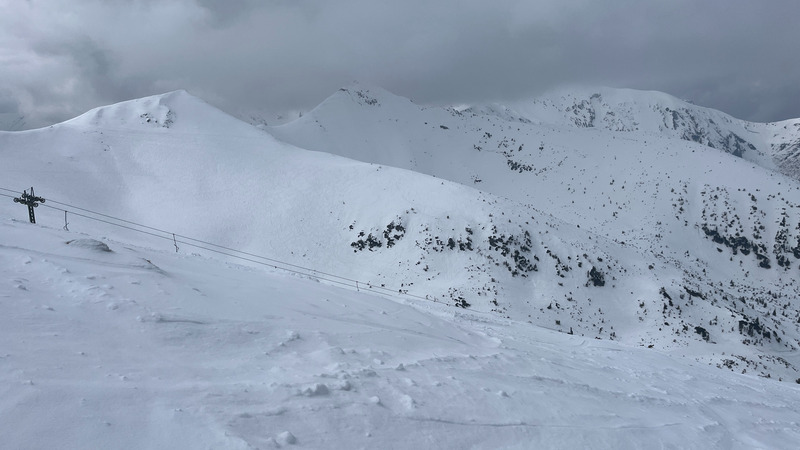 Ski lifts line the saddles near the summit.