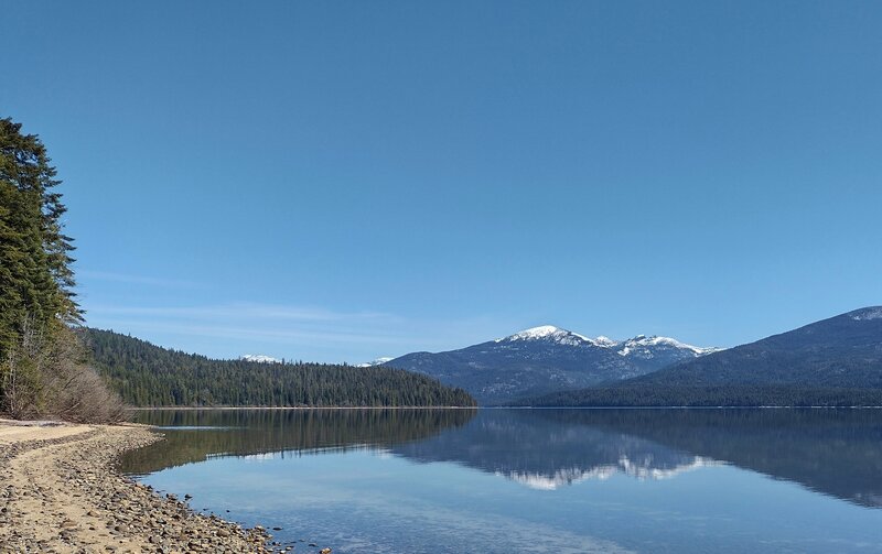 Beautiful sand beaches, and crystal clear waters of Priest Lake, with the Selkirk Mountains in the distance.