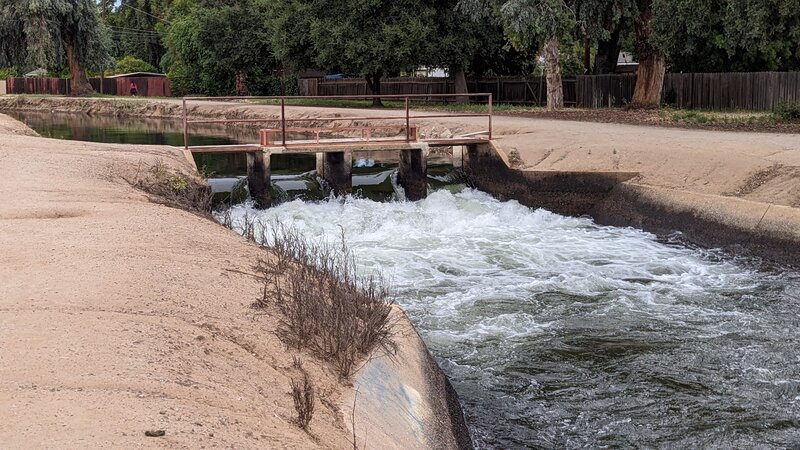 Water rushing past flood control gate.