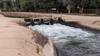 Water rushing past flood control gate.