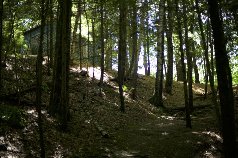 The trail climbs past a cottage where the artist in residence works in the park.