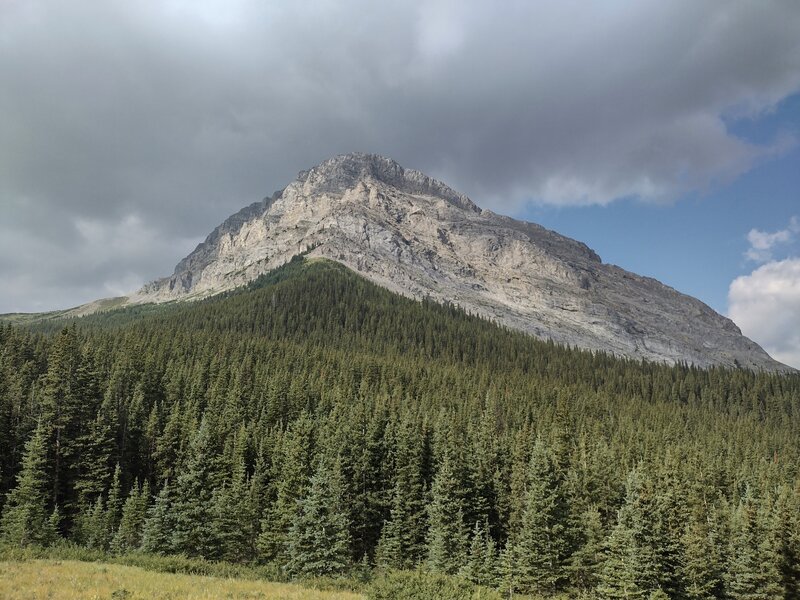 Impressive, lesser peak on the northeast shoulder of Baril Peak, 9.836 ft. Seen looking southwest from a grassy knoll along the Great Divide Trail. Baril Peak is hidden a ways behind this lesser peak.