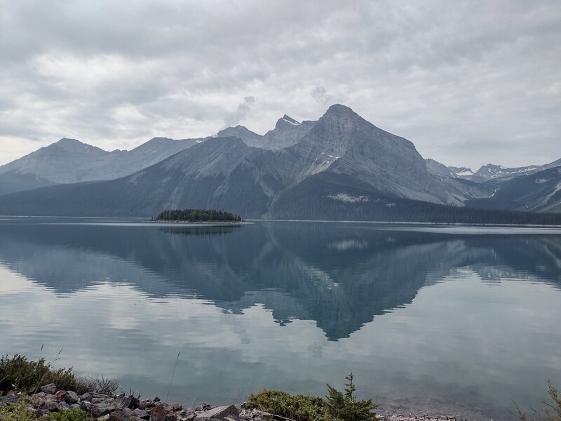 Mt. Sarrail (center nearby) looms over Upper Kananaskis Lake.  Behind Mt Sarrail as it rises from the lake, are peaks (left to right) Mt Fox, 9,754 ft., Mt Foch, 10,479 ft. (2 peaks), and Mt Sarrail summit, 10,400 ft. Mangin Glacier far distant right.