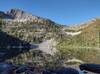 Surrounding rugged walls are perfectly reflected in glassy Snow Lake in the early morning.