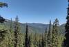 Mountains and forested valleys into the distance, are seen to the north from the high switchbacks of Bottleneck Lake Trail.