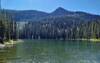 Bottleneck Peak, 6,782 ft., watches over the clear blue-green waters of Bottleneck Lake. Seen looking south from the north shore of the lake.