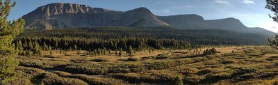 Evening sun lights up the Sheep Creek Valley and Casket Mountain. Seen from Sheep Creek Camp that overlooks the valley.