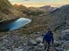 Walking up to the base of Lost Temple Spire. Sunrise lighting up the peaks of the Cirque of Towers in the distance.