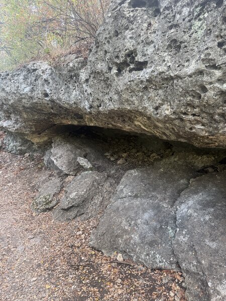 Rock formation capable of fitting a couple people underneath