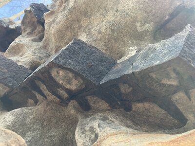 The rocks form into slightly metallic cubic formations, that weave a mesh through the rock.