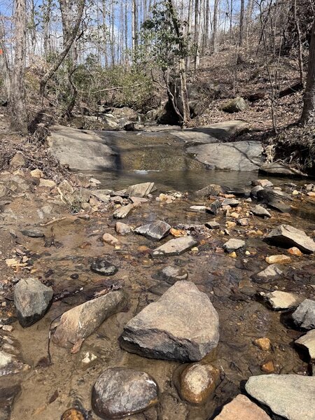 At the intersection of Orange and White Trails. Waterfall and old bridge location of the historic Sutallee Trace.