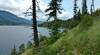 The northeast end of Upper Priest Lake, set in the beautiful mountains of northern Idaho, is seen from a grassy open spot along the trail.