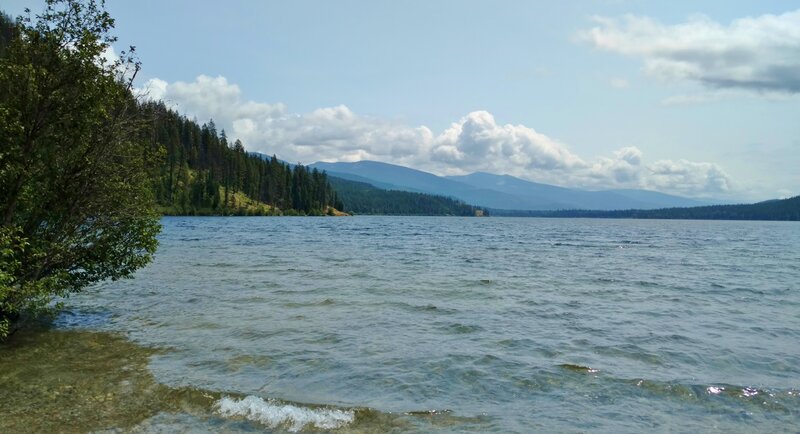 Upper Priest Lake with its pretty, rugged shoreline, and distant mountains, seen looking south from Trapper trail camp.
