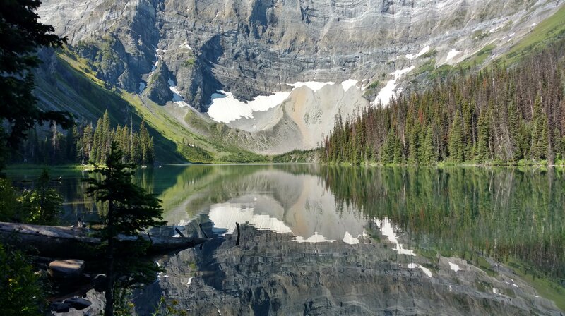 Rawson Lake is nestled in the forest below Mount Sarrail.