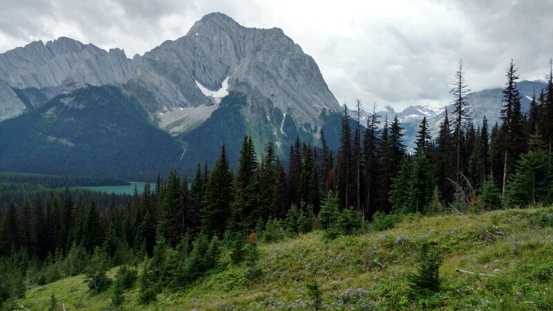 Turquoise Upper Elk Lake below (lower left), nearby Mt. Aosta, 9,823 ft., (left center), and glaciated peaks in the distance (right).