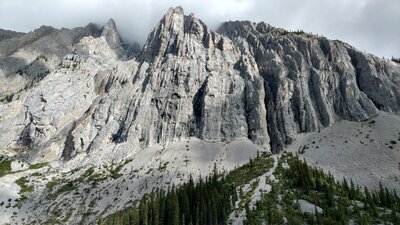Impressive cliffs of Mount Fox, 9,754 ft., rise up above Upper Elk Lake, out of sight below.