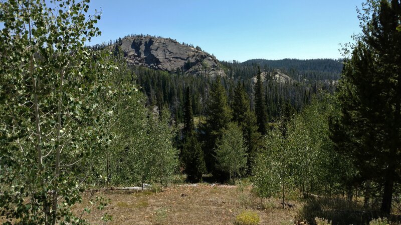 Impressive rock outcropping, with a cute liitle lake and small meadow hiding below it.