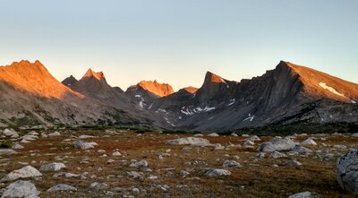 Rugged peaks catching the last light of sunset, seen looking south-southeast from the Bewmark Lake shelf above Middlefork Lake. Left to right - unnamed peak, Bailey Peak, Nylon Peak, Mount Bonneville, Pronghorn Peak, and Dragon Head Peak.
