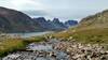 Snow melt flows into nearby Bewmark Lake in early August. Nylon Peak, 12.392 ft., (center) and Mount Bonneville, 12,585 ft., (right center) are in the distance to the south.