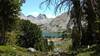 Nylon Peak and Middle Fork Lake through an opening in the trees along Bewmark Lake Trail.
