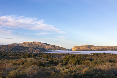 Fog covered Lake Morena with Morena Butte in the distance.