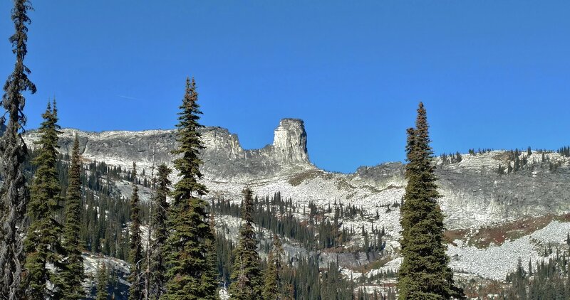 Chimney Rock (center) towers above a boulder field basin. The ridge on the left is part of the northeast shoulder of Mt. Roothaan, 7,326 ft. Both are on the Selkirk Crest.