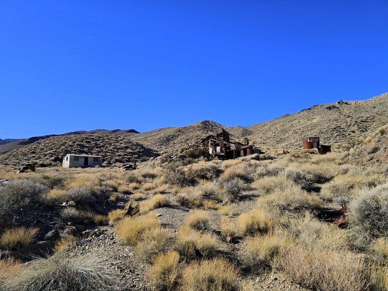 The old cabin (left), mill (center), and water tank (right) from the end of the trail.