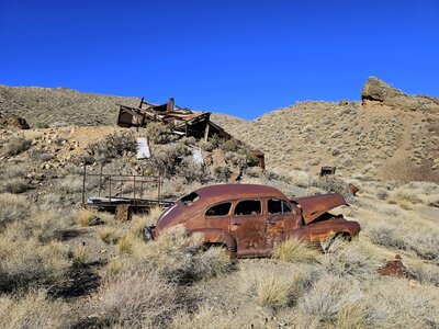 A rusty 1946 Pontiac in the foreground with the old mill behind it