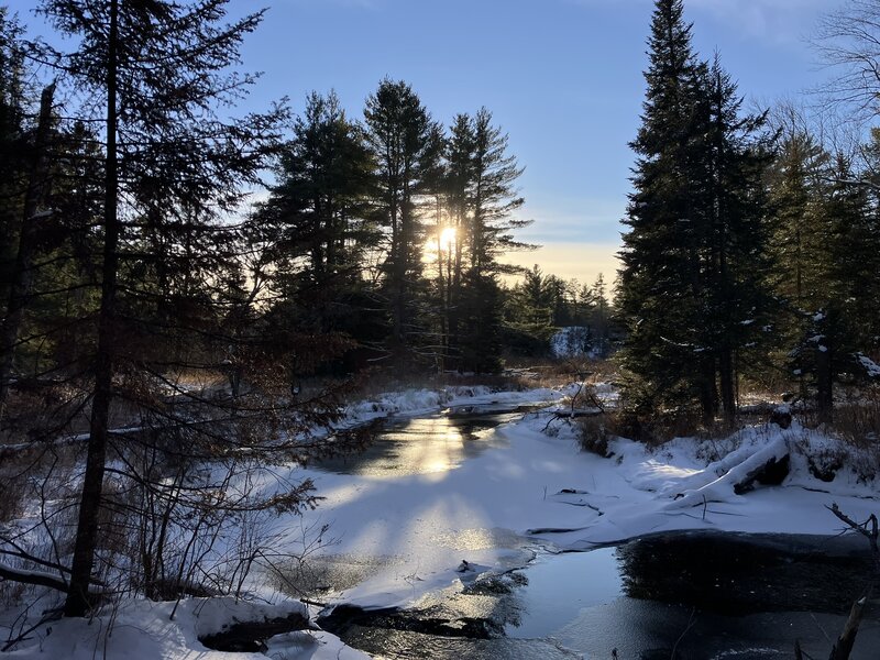 Evening sun over the Pine River.