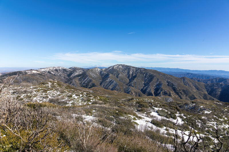 Burnt Peak and Sawmill Mountain with the snow covered San Gabriel Mountains in the distance.