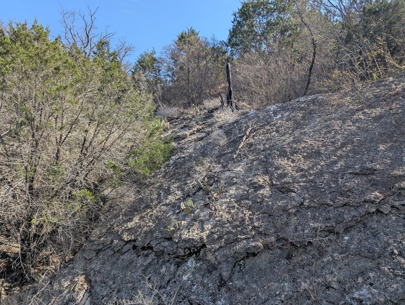 Limestone conglomerate rock formations in the steep hills along the lake.