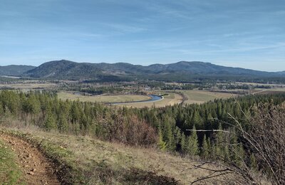 Fertile farm land below, amidst the mountains of northern Idaho. Seen near the trailhead from Quartz View Trail.